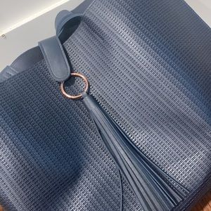 Faux leather navy bag. Very fun texture + rose gold detailing.  Never been used!